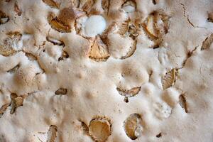 Detailed closeup top view of a freshly baked homemade apple pie texture with apple slices and golden crust. 01 photo