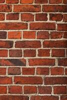 A full frame texture of a red brick weathered wall with visible aged mortar, showcasing architectural surface details and patterns 17 photo