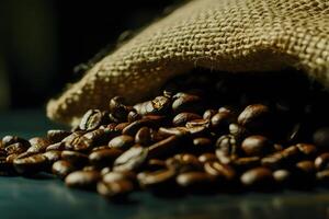 Freshly Roasted Coffee Beans Spill from a Rustic Burlap Sack on a Dark Surface Creating a Warm and Inviting Atmosphere for Coffee Lovers photo