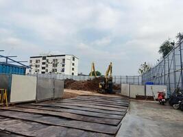 Construction site with machinery and building in background, showcasing ongoing development and urban growth photo
