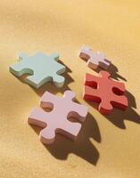 Four pieces of puzzle pieces on a yellow surface photo