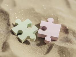 Two piece of puzzle pieces on the sand photo