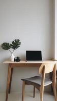 A wooden desk with a laptop and chair photo