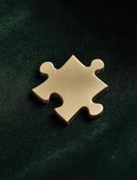Single gold puzzle piece rests elegantly, seemingly anticipating its connection to complete bigger picture, radiating sense of potential and anticipation photo