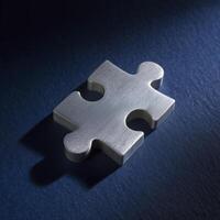 Single silver puzzle piece shines with determination on dark blue surface, symbolizing pursuit of solutions and thrill of problem solving photo