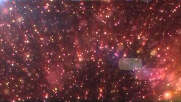 Red and golden glowing particle rain falling against a dark magical background, dreamy and festive video