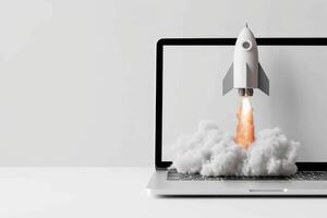 A laptop with a rocket flying out of it photo