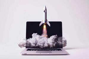 A laptop computer with a rocket on top of it photo