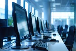 A row of computer monitors in an office photo