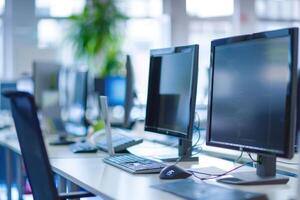 A row of computer monitors on a desk photo
