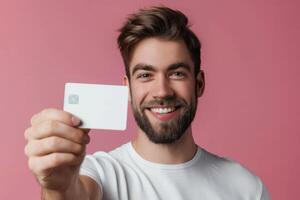A man holding up a credit card photo