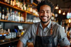 A smiling black man in an apron standing in front of a bar photo