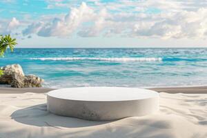 A white round table on the beach with a view of the ocean photo