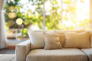 A couch with pillows and a window in front of it photo