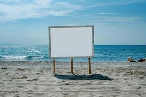 Blank billboard on the beach with ocean in background photo