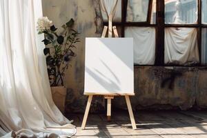 An easel with a blank canvas in front of a window photo