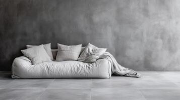 Cozy sofa with pillows and a blanket against a textured gray wall, minimalist design photo