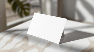 Blank card on a table with a window in the background photo