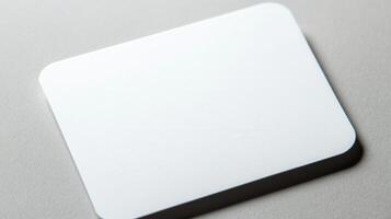 A white square mouse pad on a gray surface photo