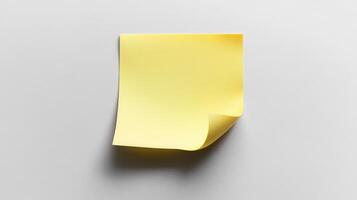 A yellow sticky note on a white surface photo