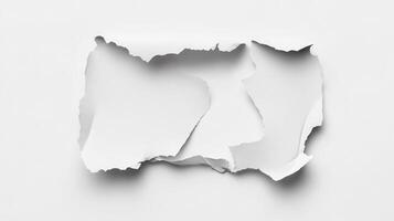 A piece of paper torn in half on a white surface photo