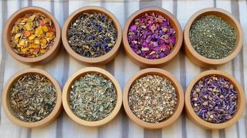 A variety of herbs in wooden bowls photo