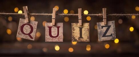 The colorful letters spelling quiz hanging on a string in warm lighting. photo