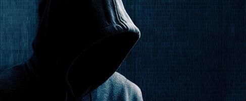 The mysterious hooded figure in a dark atmosphere conveying anonymity and intrigue. photo