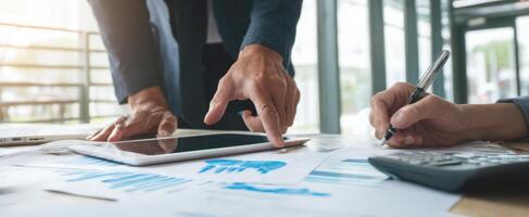 The collaborative effort of professionals analyzing financial data on a tablet. photo
