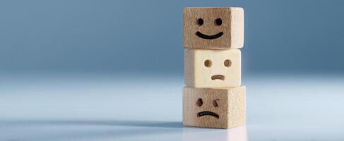 The wooden blocks expressing emotions of happiness and sadness in balanced arrangement. photo