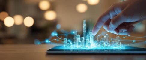 The futuristic cityscape emerging from a touch on a digital tablet. photo