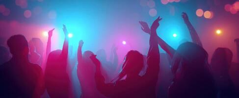 The vibrant dance party scene filled with silhouettes and colorful lights. photo