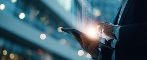 The business professional analyzing financial data on a digital tablet in an urban setting. photo