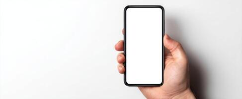 The smartphone held in a hand showcasing a blank screen for mockup purposes. photo
