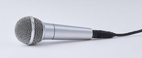 The microphone resting on a clean, minimalist surface for audio recording. photo