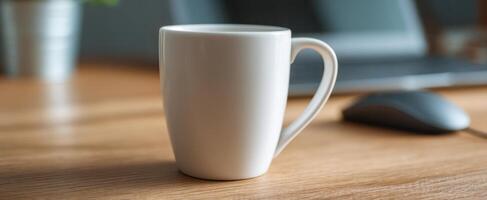 The white ceramic mug on a wooden desk in a cozy workspace setting. photo