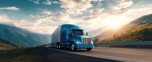 The bold blue truck cruising along a scenic mountain highway at sunset. photo