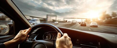 The Close-Up View of Hands Steering a Car on a Scenic Highway Drive photo