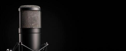 The microphone stands ready for a powerful vocal performance in a studio. photo