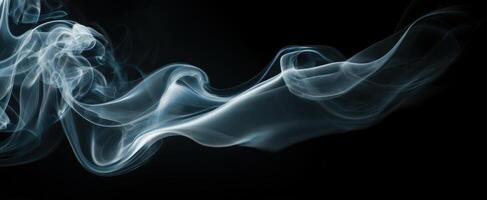 The swirling smoke creating an ethereal and abstract composition on a black background. photo
