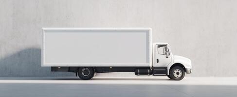 The clean white delivery truck parked against a minimalist concrete wall. photo