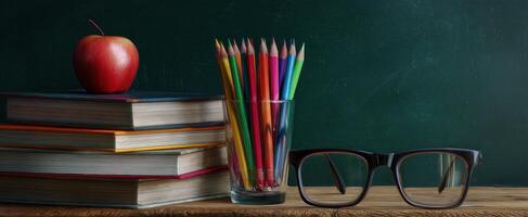 The vibrant classroom essentials featuring books, pencils, and an apple. photo