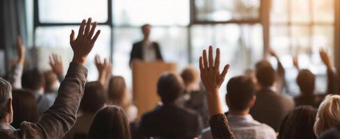 The audience raising hands during a dynamic presentation at a conference. photo