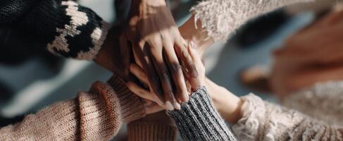 The hands of friendship coming together in a show of unity and support. photo