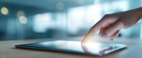 The Hand Interacting with a Touchscreen Tablet in a Modern Workspace photo