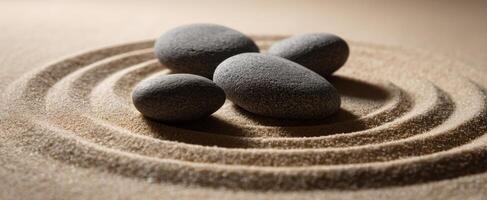 The tranquil stones resting on sand in swirling patterns photo