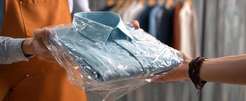 The delivery of a freshly pressed blue shirt to a satisfied customer. photo