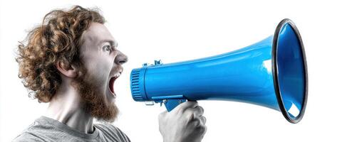 The man passionately shouting into a blue megaphone in a studio setting. photo