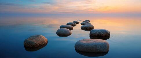 The serene stones leading to a tranquil sunset over the water. photo