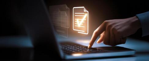 The hand interacting with a laptop displaying a digital verification document. photo